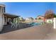 Backyard pool with patio table and chairs, surrounded by green turf and block wall fence at 7810 W Beryl Ave, Peoria, AZ 85345