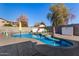Sparkling pool with umbrellas, spa, and ample space for outdoor lounging on a sunny day at 7810 W Beryl Ave, Peoria, AZ 85345
