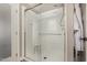 Clean and modern shower with clear glass door and white tile surround at 7810 W Beryl Ave, Peoria, AZ 85345
