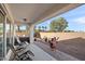 Relaxing backyard featuring covered patio, spa, desert landscaping, and outdoor fireplace at 7936 S 7Th Way, Phoenix, AZ 85042