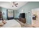 This is a spacious bedroom featuring a ceiling fan and a TV at 7936 S 7Th Way, Phoenix, AZ 85042