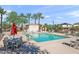 A large community pool surrounded by palm trees and lounge chairs, perfect for relaxation at 7936 S 7Th Way, Phoenix, AZ 85042