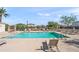 Community pool featuring multiple lounge chairs, tables, and umbrellas for resident's enjoyment at 7936 S 7Th Way, Phoenix, AZ 85042