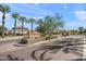 Stone community sign with palm trees and paved entry leading to gated community at 7936 S 7Th Way, Phoenix, AZ 85042