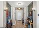 Inviting foyer with elegant lighting, neutral paint and tile, and wine decor at 7936 S 7Th Way, Phoenix, AZ 85042