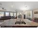Granite kitchen island with a stainless steel sink, tile floors, stainless appliances, and an open floor plan at 7936 S 7Th Way, Phoenix, AZ 85042