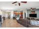 Bright living room featuring tile floors, an adjacent kitchen, living room furnishings, and decor at 7936 S 7Th Way, Phoenix, AZ 85042