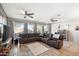 Spacious living area features tile floors, large sectional couch, ceiling fans, and backyard views at 7936 S 7Th Way, Phoenix, AZ 85042