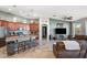 Open-concept living area with a kitchen island, bar stool seating, stainless appliances, and recessed lighting at 7936 S 7Th Way, Phoenix, AZ 85042