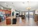 A large living room with an eat-in kitchen, modern ceiling fans, tile floors, and a large sliding glass door at 7936 S 7Th Way, Phoenix, AZ 85042