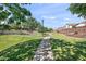 A picturesque walkway in the community with lush grass, trees, and well maintained landscaping at 7936 S 7Th Way, Phoenix, AZ 85042