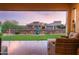 Inviting backyard with covered patio, manicured lawn, and water feature offering serene views at 8691 E Eastwood Cir, Carefree, AZ 85377
