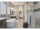 Luxurious bathroom with a standalone tub, glass shower, and walk-in closet access at 8691 E Eastwood Cir, Carefree, AZ 85377