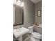 Cozy half-bathroom with a pedestal sink and a modern toilet at 8691 E Eastwood Cir, Carefree, AZ 85377