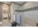 Contemporary bathroom showcasing a tiled shower with glass enclosure and an organized walk-in closet at 8691 E Eastwood Cir, Carefree, AZ 85377