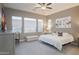 Spacious bedroom with large windows, a ceiling fan, and gray walls at 8691 E Eastwood Cir, Carefree, AZ 85377