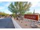 Eastwood community entrance featuring desert landscaping, mature trees, and stone signage at 8691 E Eastwood Cir, Carefree, AZ 85377