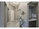 Elegant home entryway with decorative lighting, a glass table with flowers, and neutral paint at 8691 E Eastwood Cir, Carefree, AZ 85377