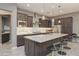 Modern kitchen with stainless steel appliances, a spacious island, and stylish pendant lighting at 8691 E Eastwood Cir, Carefree, AZ 85377