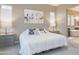 Serene main bedroom with ample natural light, neutral tones, and a view into the bathroom at 8691 E Eastwood Cir, Carefree, AZ 85377
