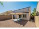 A backyard with gravel cover has a covered patio and privacy wall, offering a low-maintenance outdoor space at 8854 W Aster Dr, Peoria, AZ 85381