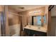 Bathroom features a double sink vanity, large mirror, and a shower-tub combination at 8854 W Aster Dr, Peoria, AZ 85381