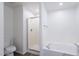 Bathroom with a glass enclosed shower, tub, and toilet at 8854 W Aster Dr, Peoria, AZ 85381