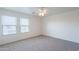 Well-lit bedroom with two windows and neutral carpet at 8854 W Aster Dr, Peoria, AZ 85381