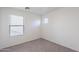A bedroom with a neutral color scheme, carpeted flooring, and a window with blinds at 8854 W Aster Dr, Peoria, AZ 85381