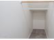 A walk-in closet with carpeted flooring and a wooden hanging rod at 8854 W Aster Dr, Peoria, AZ 85381