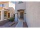 Inviting entrance with a covered doorway, desert landscaping, and a secure gate at 8854 W Aster Dr, Peoria, AZ 85381