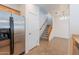 The home's entryway with tile flooring, stairs, and stainless steel refrigerator at 8854 W Aster Dr, Peoria, AZ 85381