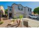 Well-maintained townhome with attached two-car garage and low-maintenance desert landscaping at 8854 W Aster Dr, Peoria, AZ 85381