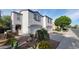 Two-story home boasts a well-maintained yard with decorative rock and a spacious two-car garage at 8854 W Aster Dr, Peoria, AZ 85381