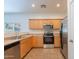 Kitchen featuring tile flooring, stainless steel appliances and wooden cabinets at 8854 W Aster Dr, Peoria, AZ 85381