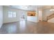 Open-concept living room featuring tile floors, a ceiling fan, and access to the backyard at 8854 W Aster Dr, Peoria, AZ 85381