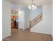 Living room area adjacent to the kitchen with access to the staircase at 8854 W Aster Dr, Peoria, AZ 85381