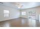 Bright living room with neutral walls, tile flooring, ceiling fan and a sliding door to the backyard at 8854 W Aster Dr, Peoria, AZ 85381