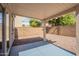 A covered outdoor patio area features a gravel ground cover and block wall, perfect for relaxed outdoor living at 8854 W Aster Dr, Peoria, AZ 85381