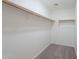 Walk-in closet with shelves, rod, and neutral carpeting at 8854 W Aster Dr, Peoria, AZ 85381