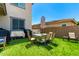 Outdoor dining set on artificial grass, offering a comfortable space for backyard relaxation at 9342 W White Feather Ln, Peoria, AZ 85383