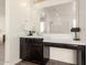 Bright bathroom with vanity, mirror, countertop, and a convenient makeup vanity area at 9342 W White Feather Ln, Peoria, AZ 85383