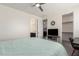 Bedroom view showcasing an ensuite bathroom, walk-in closet, and mounted TV at 9342 W White Feather Ln, Peoria, AZ 85383