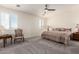 Comfortable bedroom featuring carpeted floors, a bed, lamps, and two windows for ample natural light at 9342 W White Feather Ln, Peoria, AZ 85383