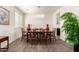 Bright dining room featuring decorative lighting, sleek tile flooring, and ample space for entertaining at 9342 W White Feather Ln, Peoria, AZ 85383