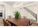 Well-lit dining room boasts decorative lighting and staircase access, perfect for intimate gatherings at 9342 W White Feather Ln, Peoria, AZ 85383