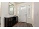 Inviting foyer with wood floors, a console table, and a well-lit entrance, creating a warm welcome at 9342 W White Feather Ln, Peoria, AZ 85383