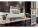 Gourmet kitchen with stainless-steel appliances, granite counters, and designer cabinetry at 9342 W White Feather Ln, Peoria, AZ 85383