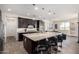 Open-concept kitchen with granite counters, stainless appliances, and spacious island with bar seating at 9342 W White Feather Ln, Peoria, AZ 85383