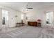 Spacious living room area with neutral carpet, ceiling fan, and ample space for furnishings at 9342 W White Feather Ln, Peoria, AZ 85383